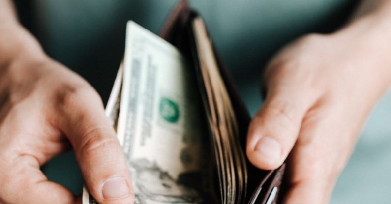 Budget Meals - Crop man getting dollars from wallet