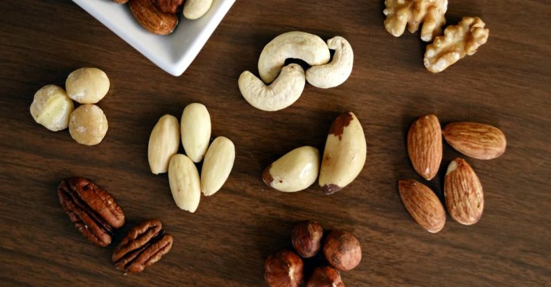 Healthy Snacks - Variety of Brown Nuts on Brown Wooden Panel High-angle Photo