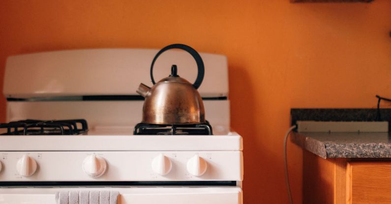 International Cuisine - A white stove and oven in an orange kitchen