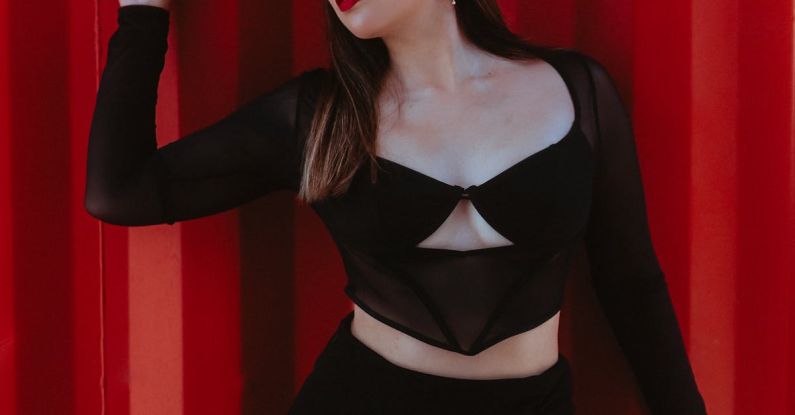 Budget Fashion - Woman Posing in Front of Red Curtain