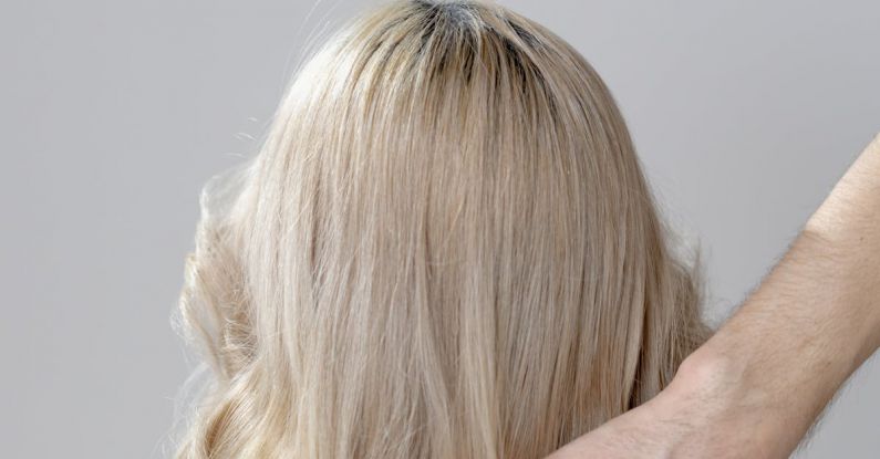 Haircare Tips - Photo of a Person's Hand Touching Blond Hair