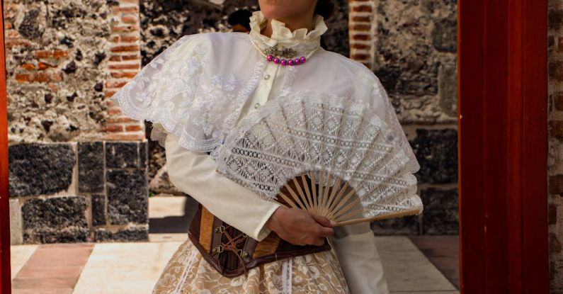 Accessorize Outfit - A woman in a traditional dress holding a fan