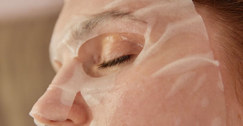 Anti-aging Skincare - A Close-up Shot of a Woman with a Sheet Mask on Face