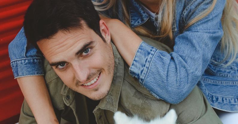 Family Milestones - A couple posing with a dog in front of a red truck