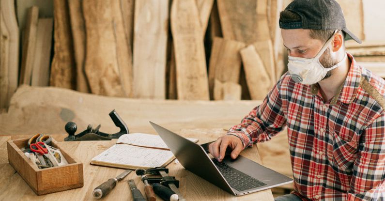 DIY Furniture - Man Using a Laptop at a Wood Workshop