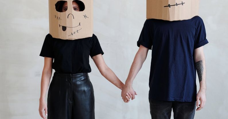 DIY Wall Art - A Couple Wearing Diy Cardboard Box Mask While Holding Each Other's Hands