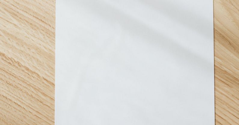 Home Organizing - Blank white paper sheet on wooden table