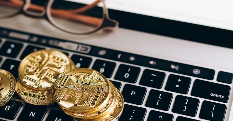 Beginner Investing - Bitcoins and a Laptop with Monitor Displaying a Chart